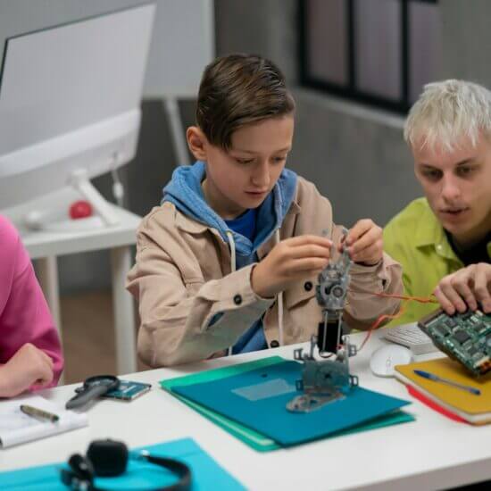 Children engaged in STEM robotics project.