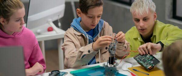 Children engaged in STEM robotics project.