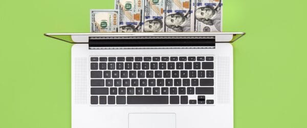 a laptop with money on it