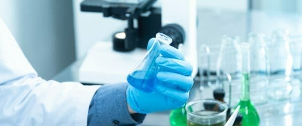 person holding laboratory flask