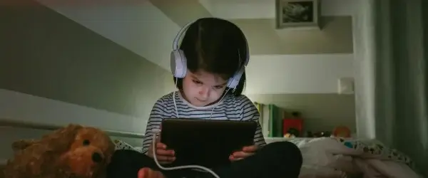 girl with headphones looking tablet